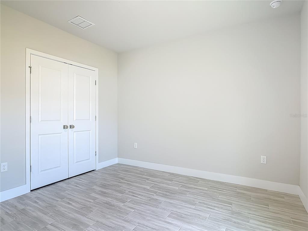 60 Ballenger Lane Palm Coast, FL 32137 - Photo 44 of 60 a view of an empty room with wooden floor