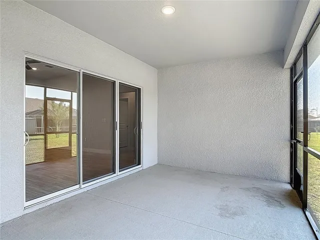 an aerial view of residential houses with outdoor space and trees