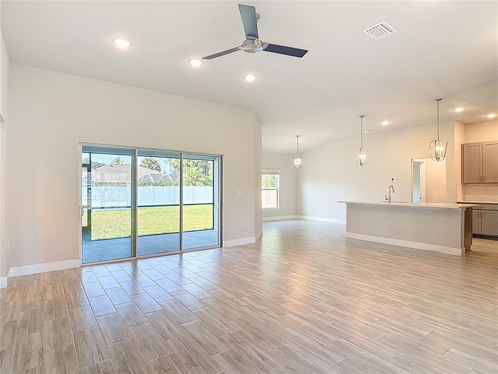 60 Ballenger Lane Palm Coast, FL 32137 - Photo 7 of 60 a view of an empty room with wooden floor and a window