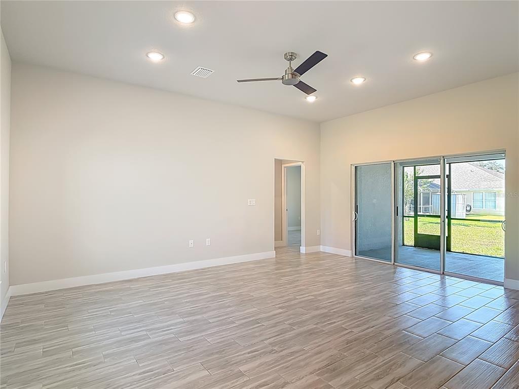 60 Ballenger Lane Palm Coast, FL 32137 - Photo 9 of 60 a view of an empty room with wooden floor and a window