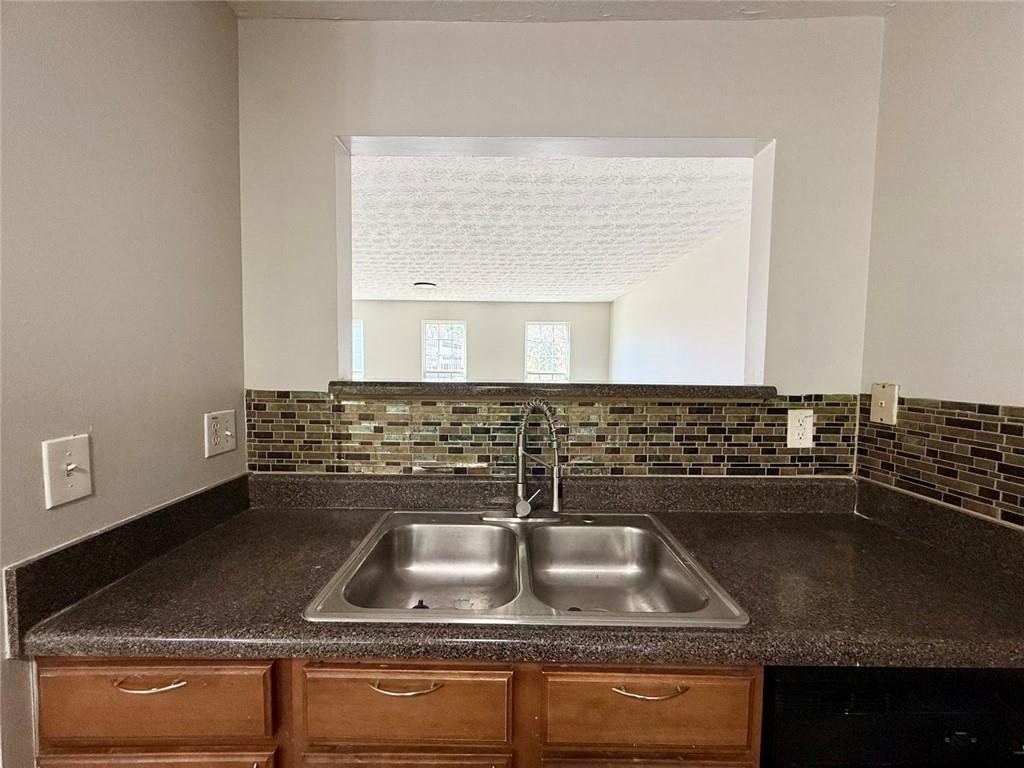 1708 Redan East Lithonia, GA 30058 - Photo 26 of 26 a bathroom with a granite countertop sink a mirror and vanity