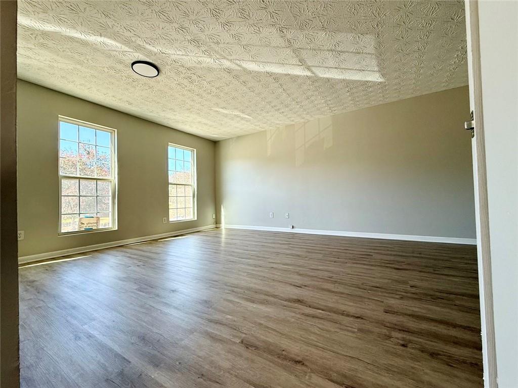 1708 Redan East Lithonia, GA 30058 - Photo 8 of 26 wooden floor in an empty room with a window