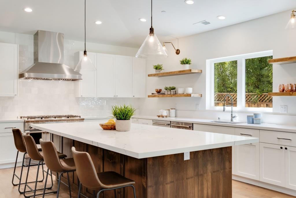 1057 Covington Road Los Altos, CA 94024 - Photo 11 of 31 a kitchen with stainless steel appliances a table chairs in it and wooden floors