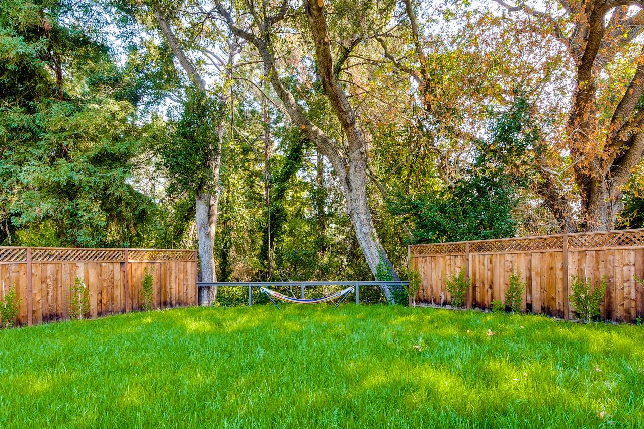 1057 Covington Road Los Altos, CA 94024 - Photo 30 of 31 a view of a backyard with wooden fence and large trees