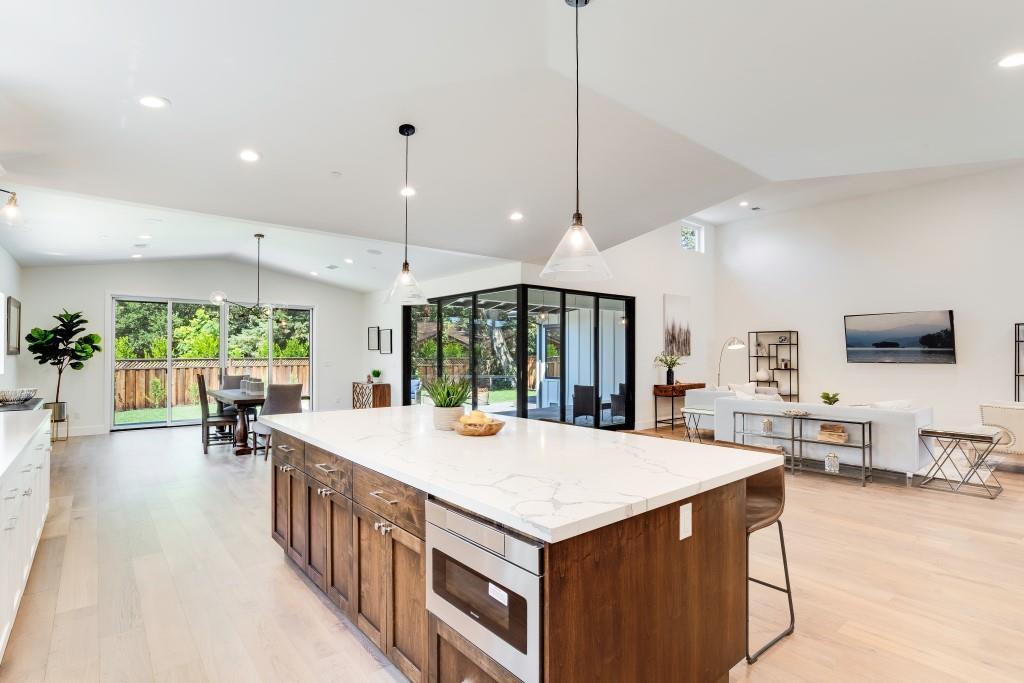 1057 Covington Road Los Altos, CA 94024 - Photo 9 of 31 a large kitchen with kitchen island a large island in it