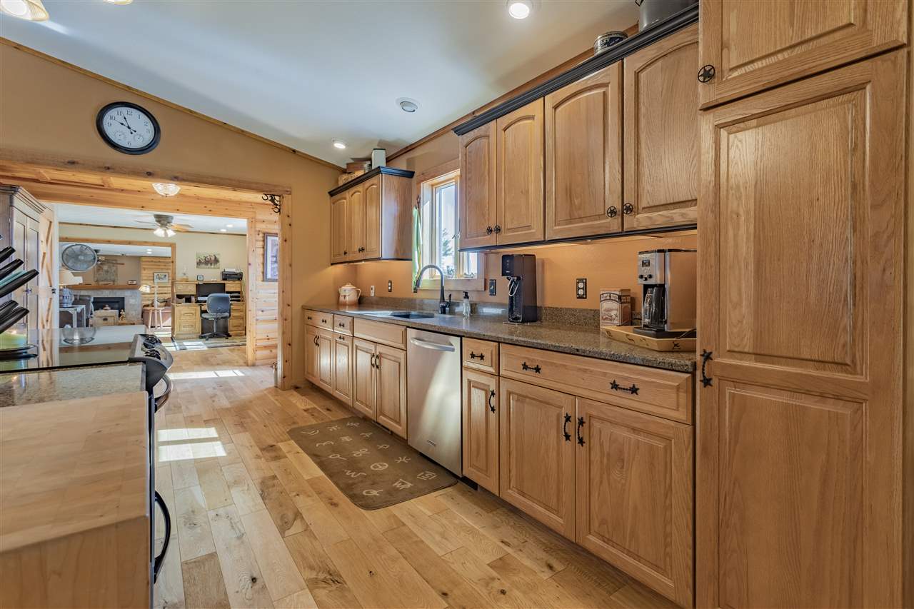 3517 North Marrill Road Byron, IL 61010 - Photo 12 of 36 a kitchen with stainless steel appliances granite countertop a refrigerator a sink and white cabinets