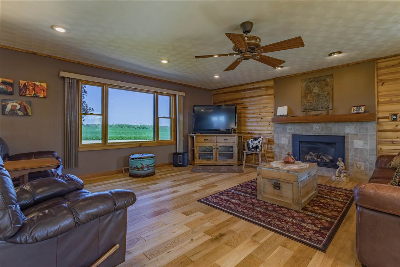 3517 North Marrill Road Byron, IL 61010 - Photo 19 of 36 a living room with furniture a fireplace and a flat screen tv