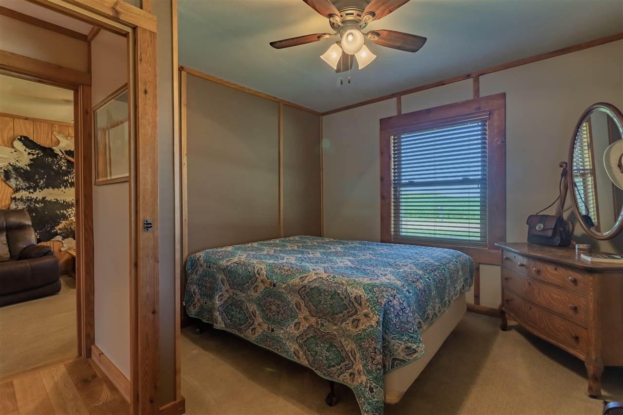 3517 North Marrill Road Byron, IL 61010 - Photo 21 of 36 a bedroom with a bed and a chandelier