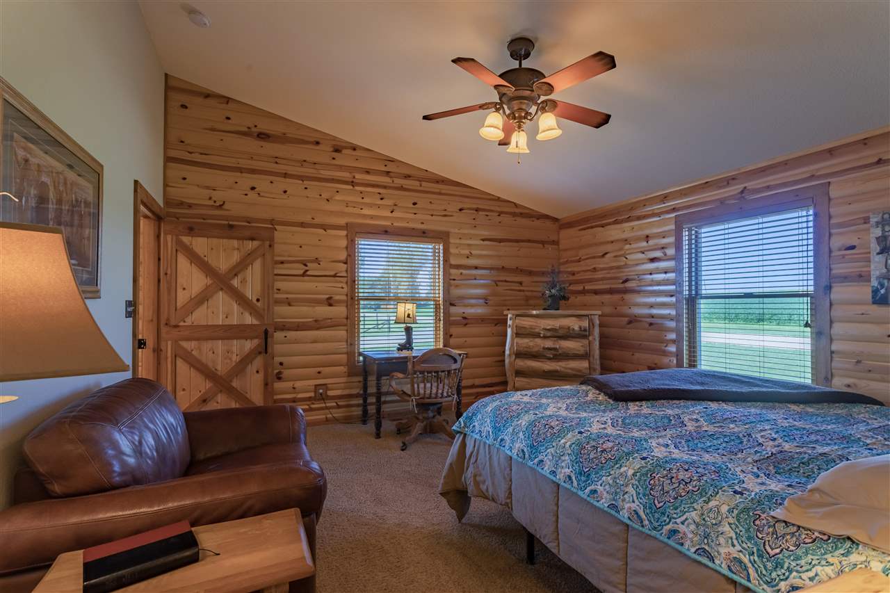 3517 North Marrill Road Byron, IL 61010 - Photo 24 of 36 a bedroom with a bed a couch and dresser
