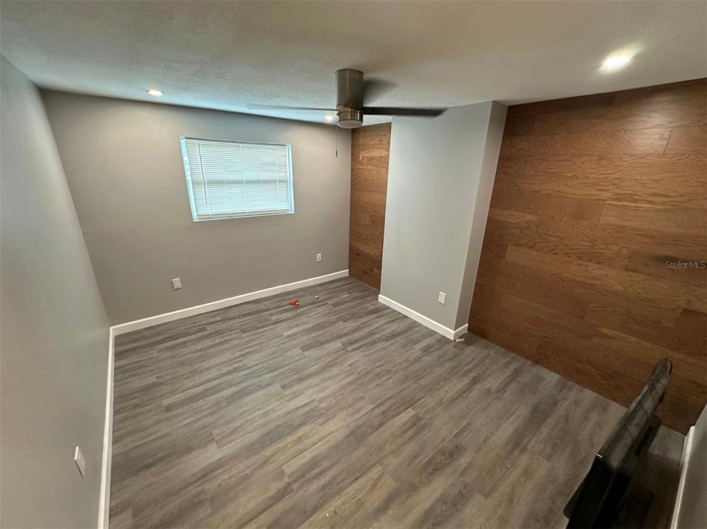 2301 Trelain Drive South St. Petersburg, FL 33712 - Photo 12 of 16 an empty room with wooden floor and windows