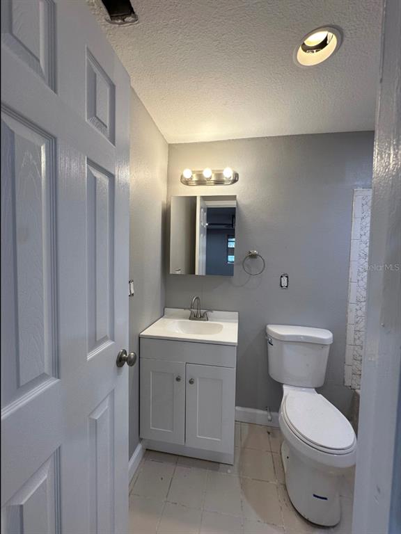 2301 Trelain Drive South St. Petersburg, FL 33712 - Photo 13 of 16 a bathroom with a toilet sink and mirror