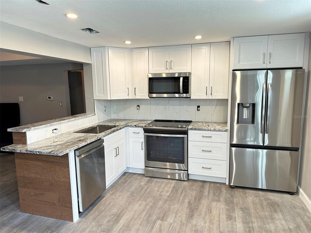 2301 Trelain Drive South St. Petersburg, FL 33712 - Photo 3 of 16 a kitchen with a refrigerator stove and sink
