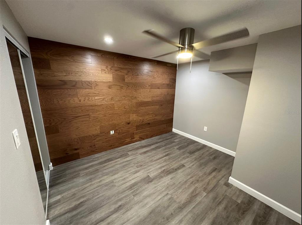 2301 Trelain Drive South St. Petersburg, FL 33712 - Photo 9 of 16 en empty room with wooden floor and fan