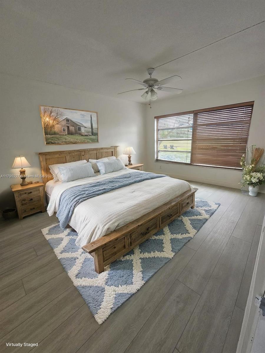 2900 North Palm Aire Drive, Unit 108 Pompano Beach, FL 33069 - Photo 11 of 17 a bedroom with a bed a mirror and a window