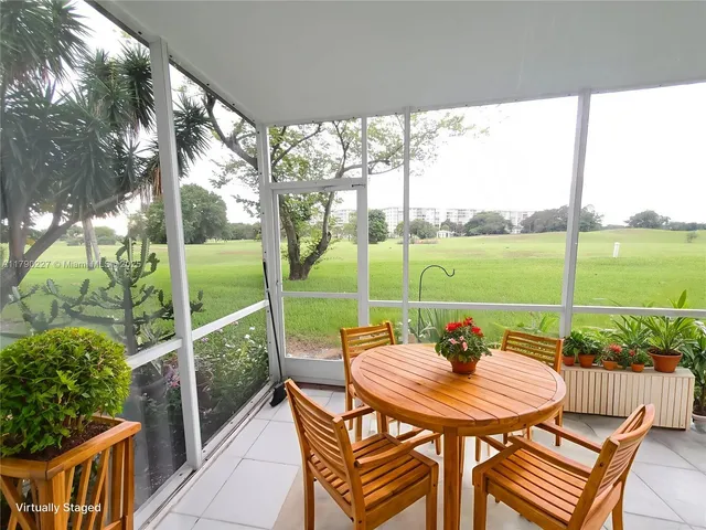 a view of a patio with table and chairs and potted plants