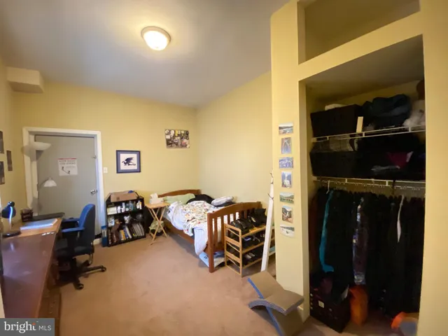 a view of a livingroom with furniture and closet