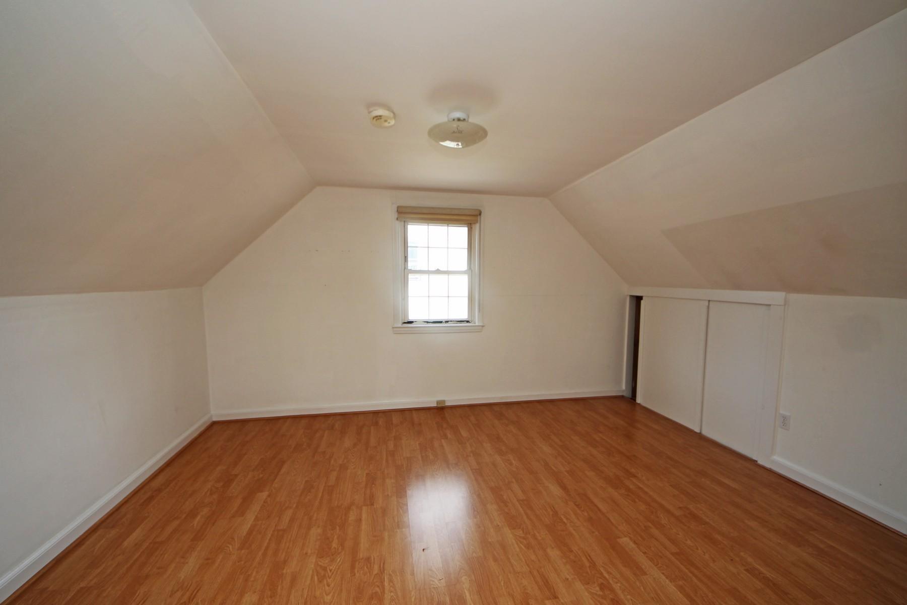 68 Maple Street Darien, CT 06820 - Photo 14 of 25 an empty room with wooden floor and windows
