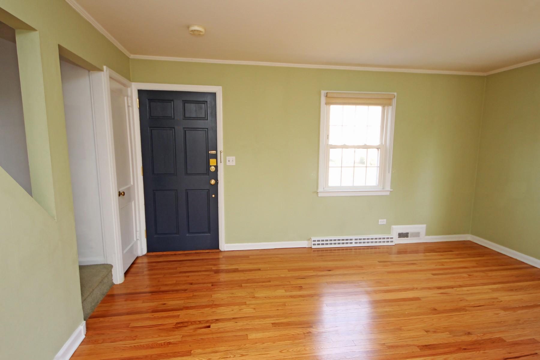 68 Maple Street Darien, CT 06820 - Photo 2 of 25 a view of an empty room with wooden floor and a window