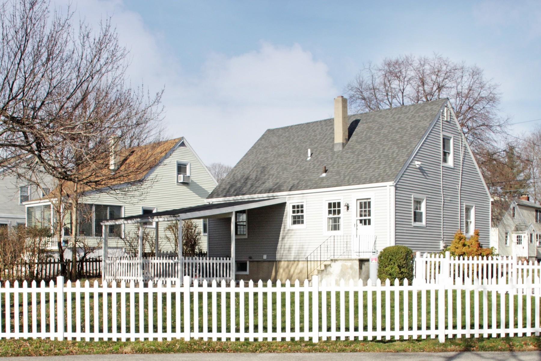 68 Maple Street Darien, CT 06820 - Photo 23 of 25 a front view of a house with a garden