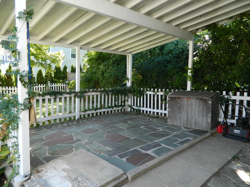 68 Maple Street Darien, CT 06820 - Photo 25 of 25 a view of a porch with wooden floor and yard