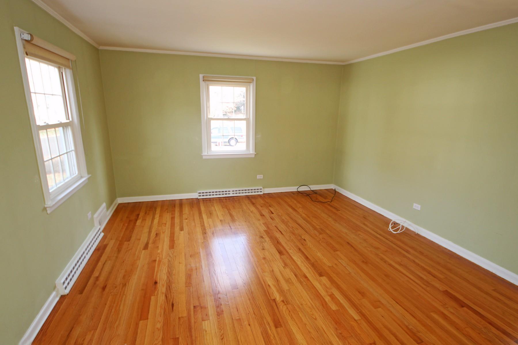 68 Maple Street Darien, CT 06820 - Photo 4 of 25 an empty room with wooden floor and windows