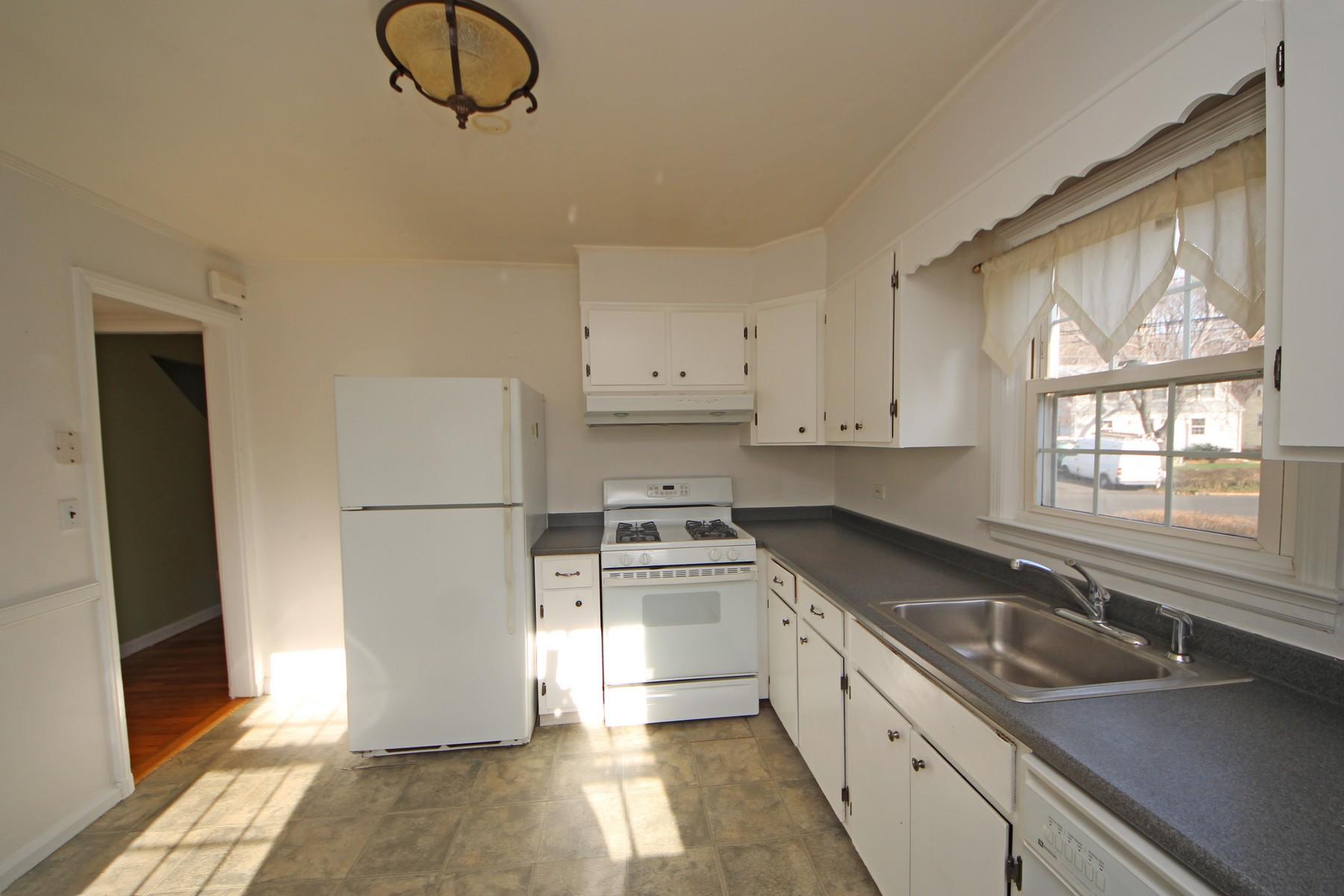 68 Maple Street Darien, CT 06820 - Photo 7 of 25 a kitchen with granite countertop a sink stainless steel appliances and cabinets