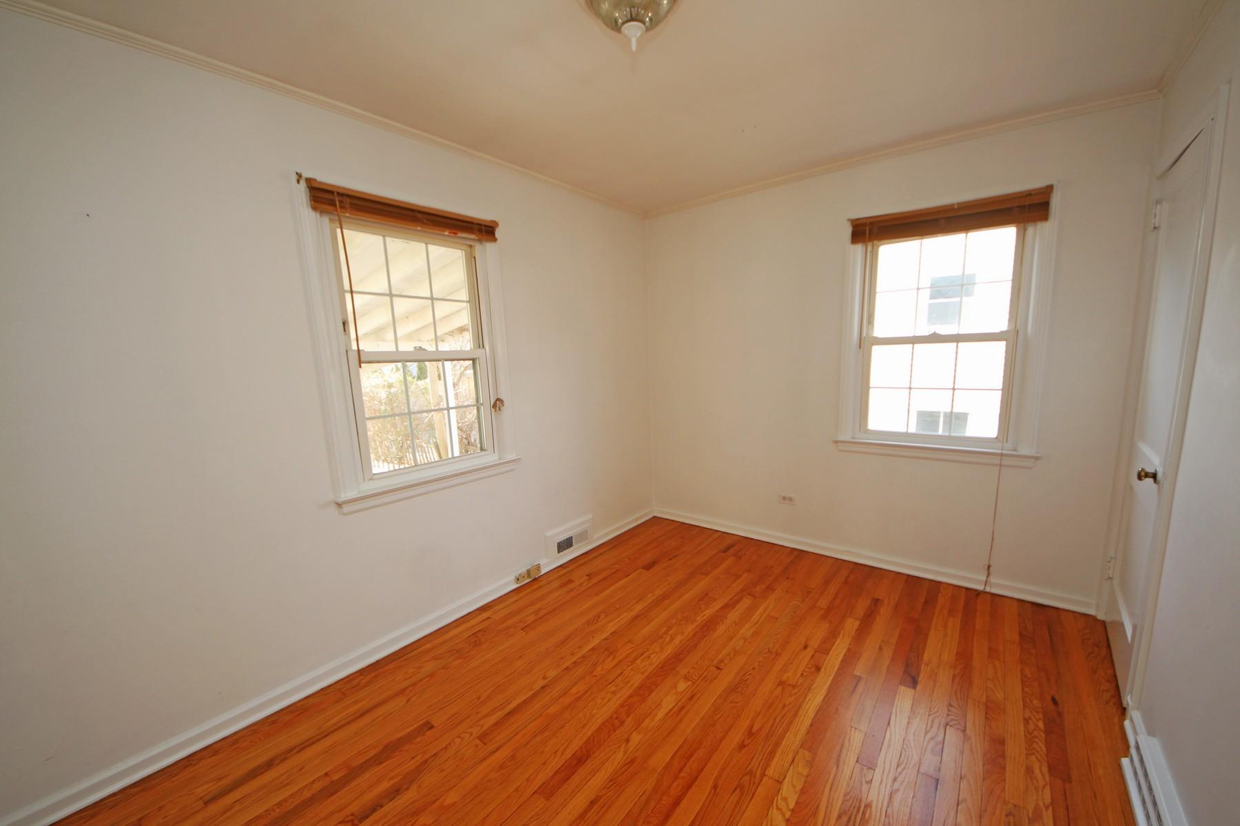 68 Maple Street Darien, CT 06820 - Photo 8 of 25 an empty room with wooden floor and windows