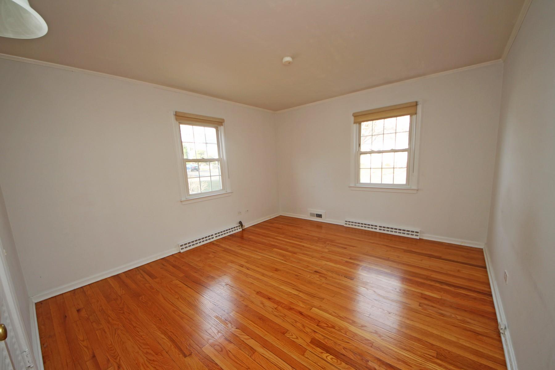 68 Maple Street Darien, CT 06820 - Photo 10 of 25 an empty room with wooden floor and windows