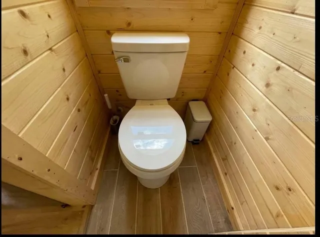 a bathroom with a toilet and a mirror