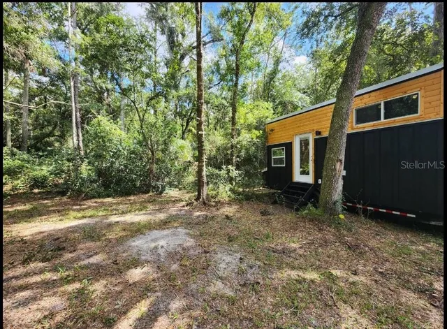 a backyard of a house with lots of green space