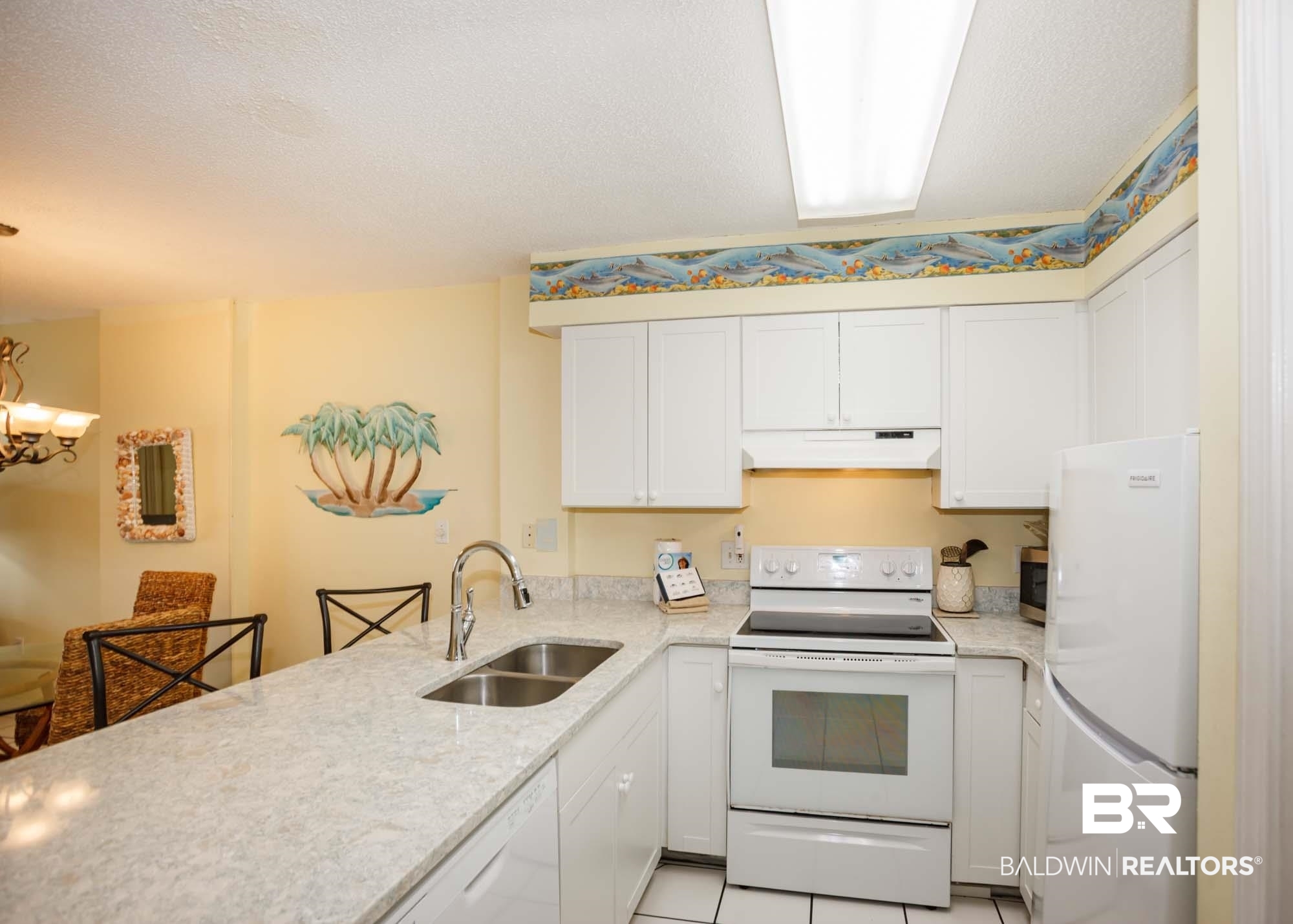 645 Plantation Road, Unit 6311 Gulf Shores, AL 36542 - Photo 40 of 43 Kitchen featuring white appliances, a sink, under cabinet range hood, a peninsula, and white cabinetry