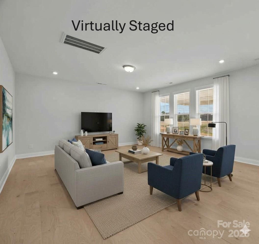 885 Regulus Court York, SC 29745 - Photo 14 of 46 a living room with furniture wooden floor and a flat screen tv