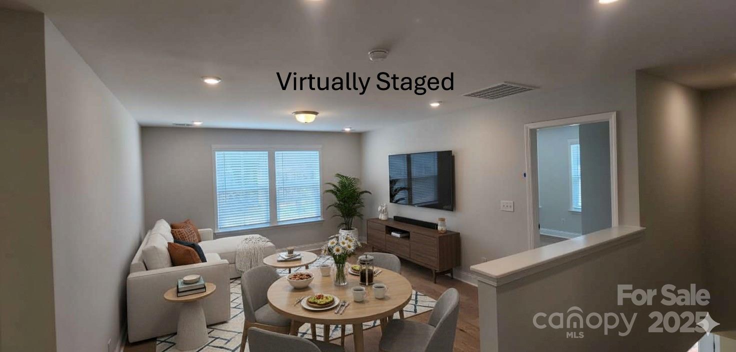 885 Regulus Court York, SC 29745 - Photo 18 of 46 a living room with furniture a flat screen tv and kitchen view