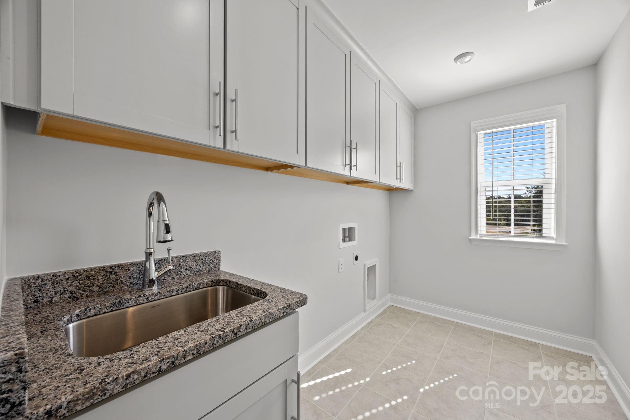 885 Regulus Court York, SC 29745 - Photo 26 of 46 a kitchen with granite countertop white cabinets and sink