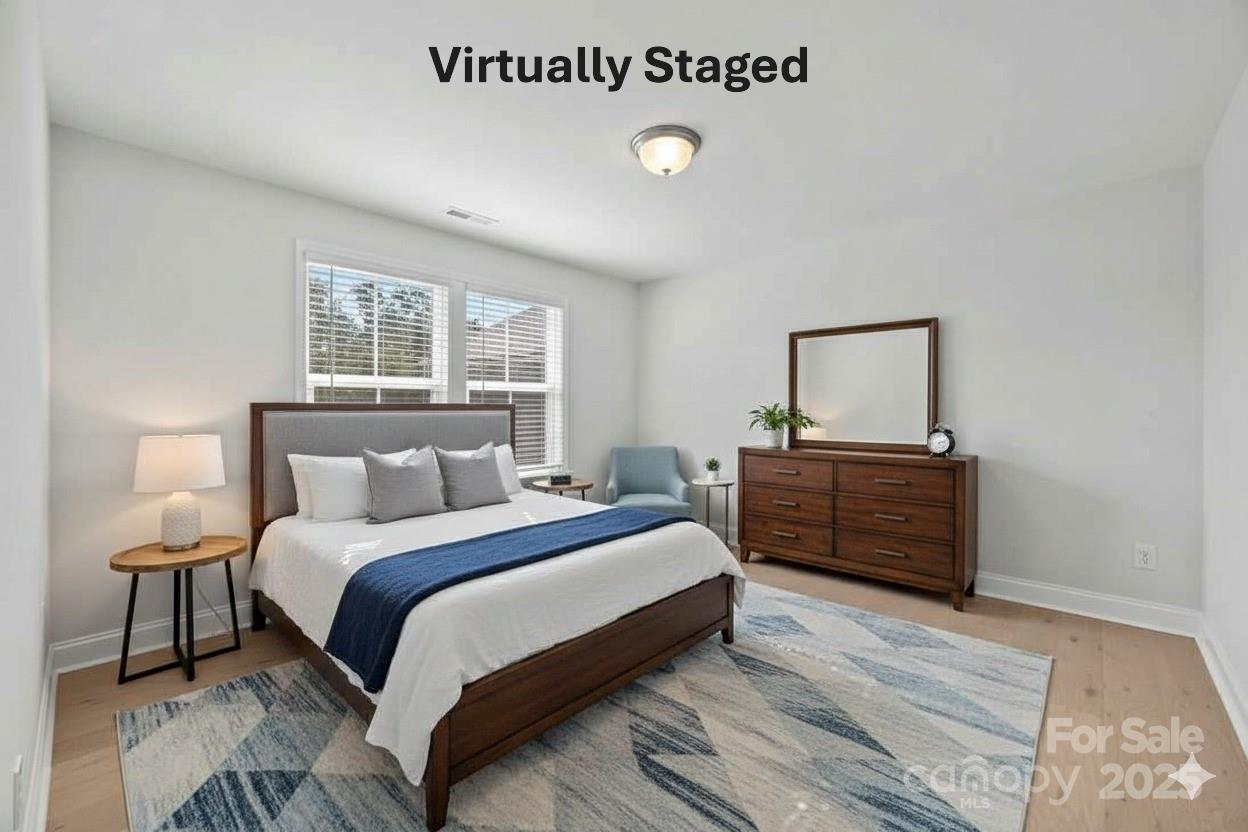 885 Regulus Court York, SC 29745 - Photo 31 of 46 a bedroom with a bed and wooden floor