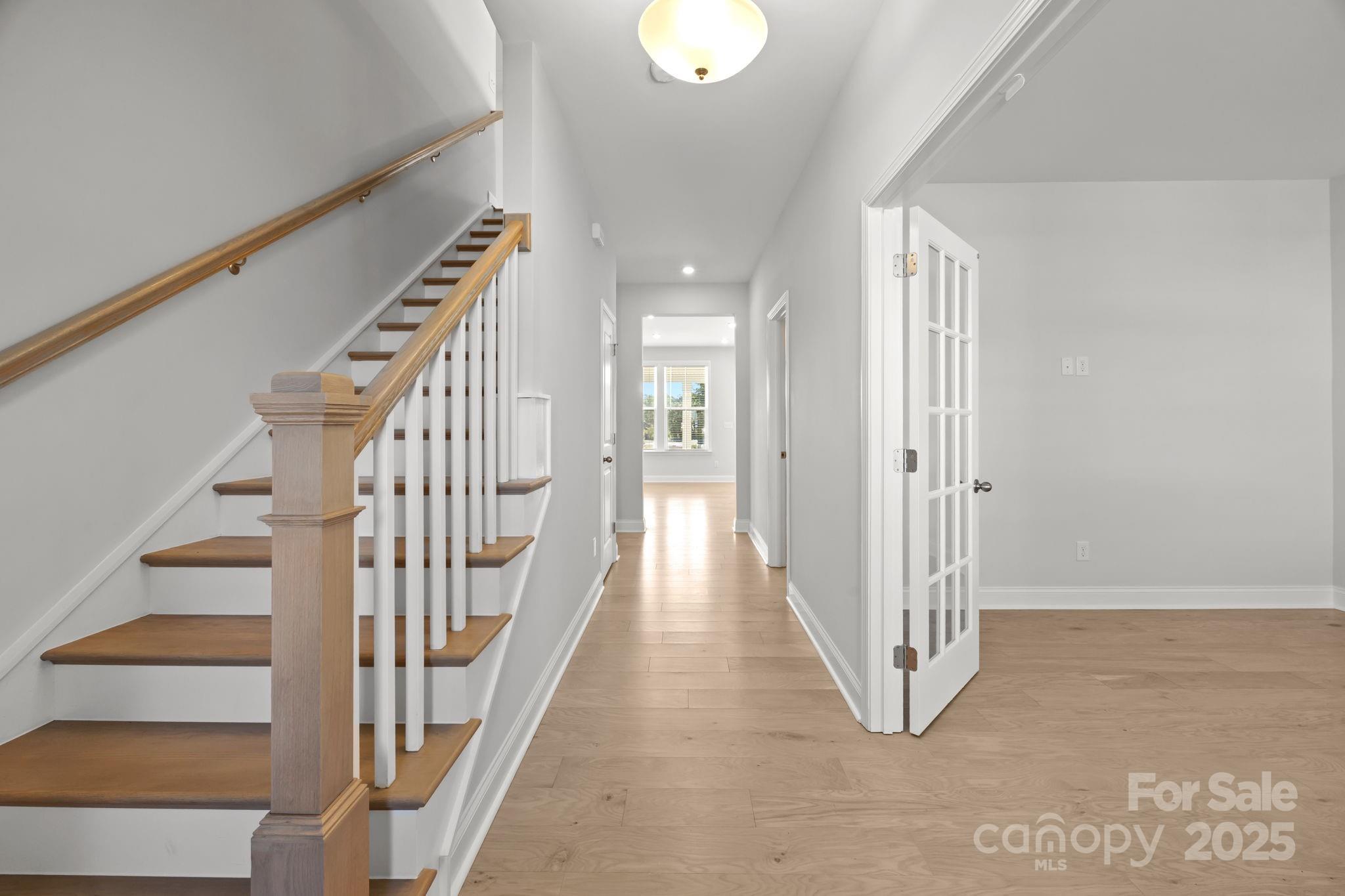 885 Regulus Court York, SC 29745 - Photo 6 of 46 a view of a hallway with wooden floor and staircase
