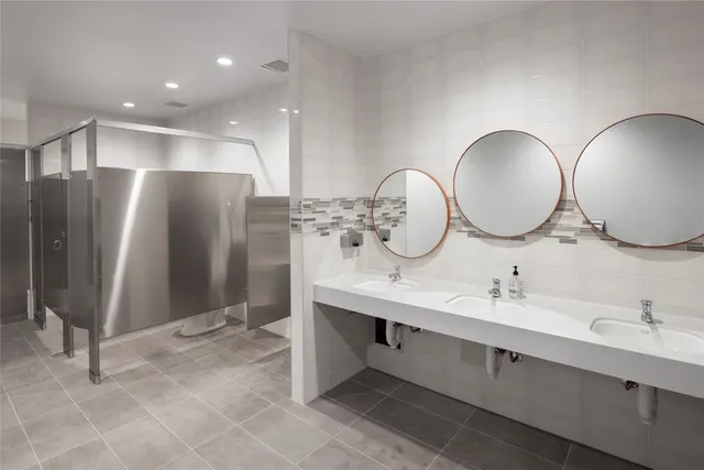 a bathroom with a double vanity sink and a mirror