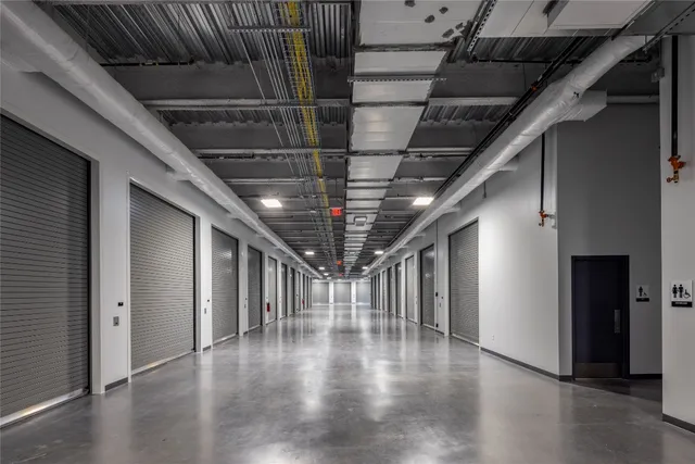 a view of hallway with stairs and wooden floor