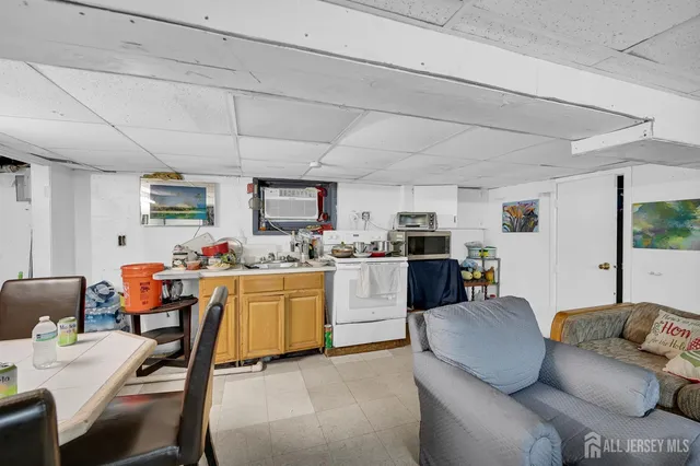 a kitchen with a dining table chairs cabinets and stainless steel appliances