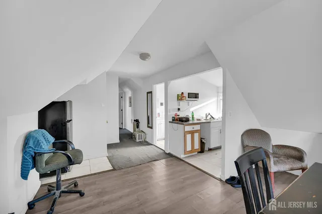 a view of a kitchen with fridge and workspace