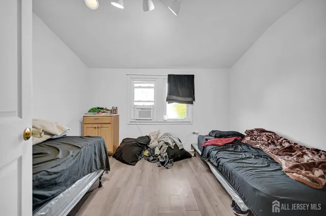 a bedroom with two beds and a lamp