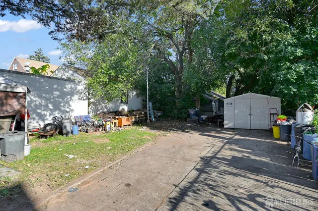 a view of a garage with a bike and white house