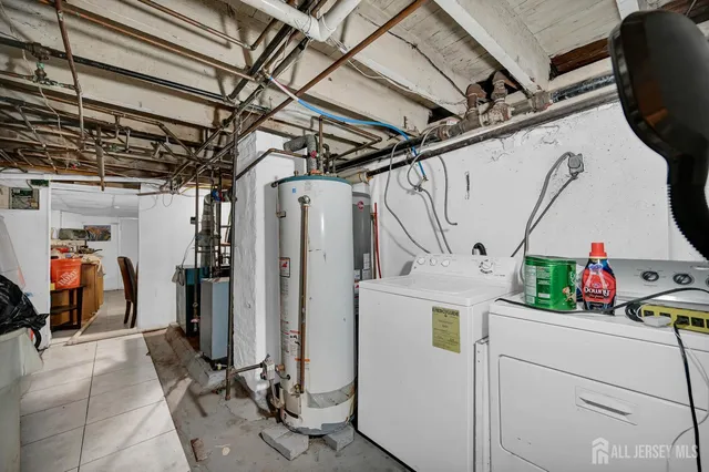 a view of storage and utility room with refrigerator and washer