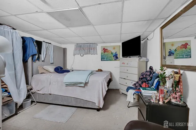 a bedroom with a bed and a tv in it