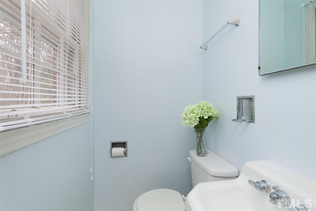 3105 Brentwood Road Raleigh, NC 27604 - Photo 17 of 25 a bathroom with a toilet sink and mirror