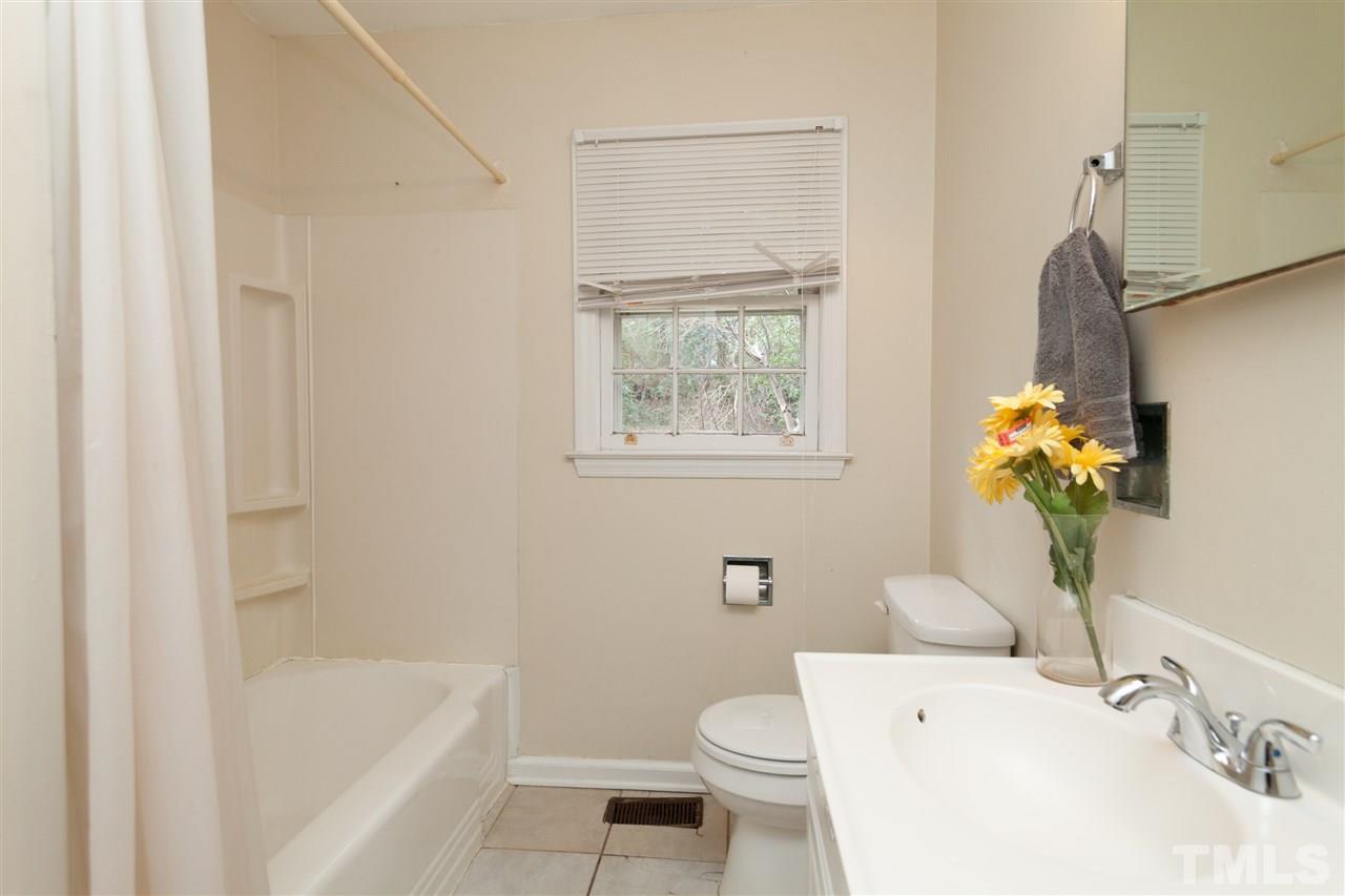 3105 Brentwood Road Raleigh, NC 27604 - Photo 20 of 25 a bath room with a toilet a sink and a bath tub