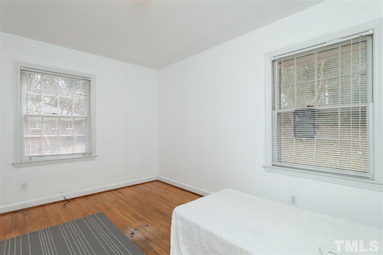3105 Brentwood Road Raleigh, NC 27604 - Photo 21 of 25 a bedroom with a bed and next to a window