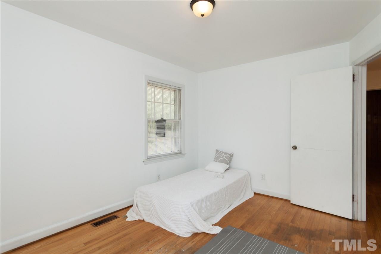 3105 Brentwood Road Raleigh, NC 27604 - Photo 22 of 25 a bedroom with a bed and a window