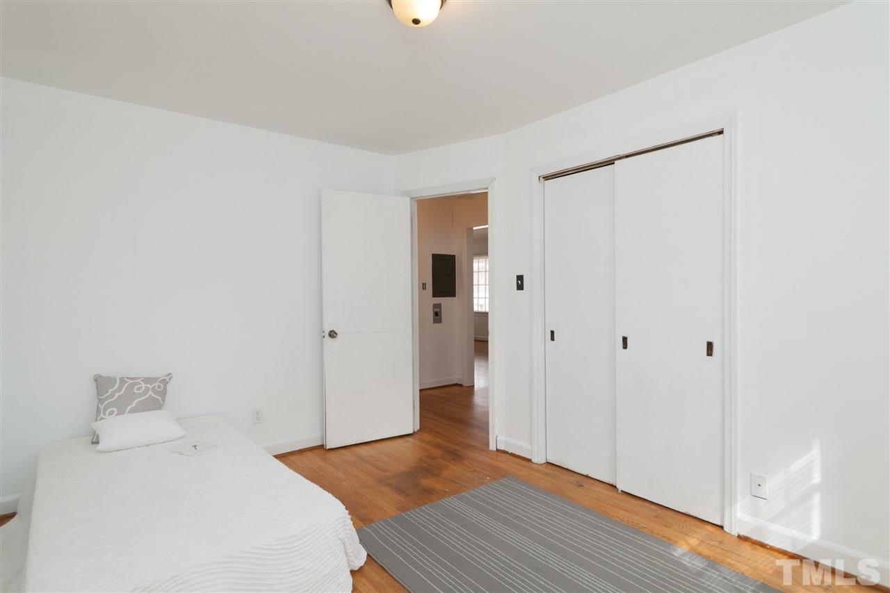 3105 Brentwood Road Raleigh, NC 27604 - Photo 23 of 25 a bedroom with a bed and wooden floor