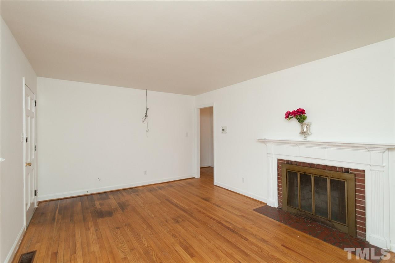 3105 Brentwood Road Raleigh, NC 27604 - Photo 6 of 25 a view of a livingroom with wooden floor and a fireplace